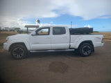  great for RV rental coastal adventures and camping by the beach.|White Toyota Tacoma TRD Sport pickup with camping setup