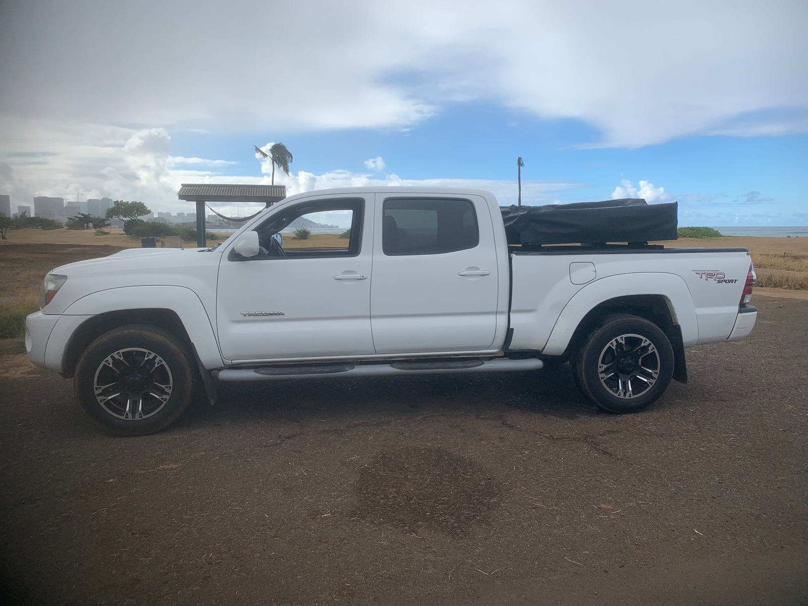  great for RV rental coastal adventures and camping by the beach.|White Toyota Tacoma TRD Sport pickup with camping setup