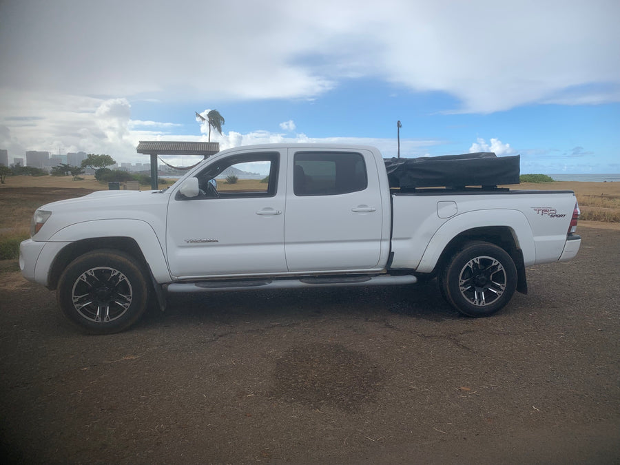  great for RV rental coastal adventures and camping by the beach.|White Toyota Tacoma TRD Sport pickup with camping setup