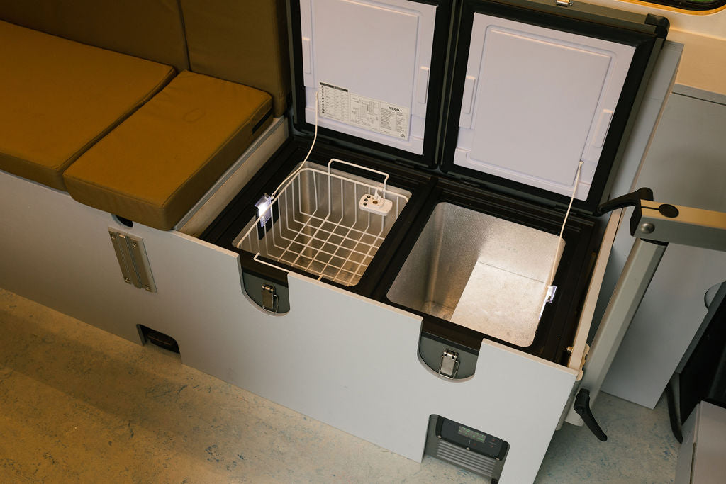 Explore RV rental adventures with this dual-zone fridge/freezer built into the interior cabinetry, complete with comfortable bench seating. — photo 10