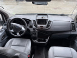 Interior of a grey Ford RV rental, detailing the driver's area with steering wheel, dashboard, and front seats.
