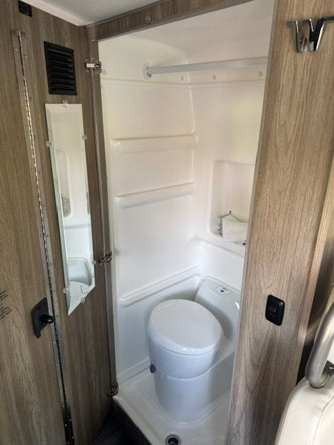  and a ladder leading from the living space.|Modern rv rental interior: kitchen counter with cooktop — photo 8