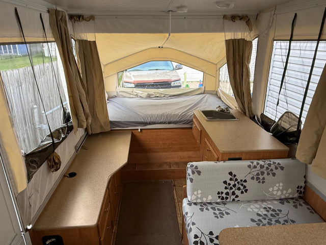 Explore this pop-up camper's interior for your rv rental! Bed