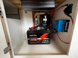 This RV rental reveals its off-grid power system: a LiFePO4 battery, inverter, and Victron DC-DC charger, essential for mobile living.