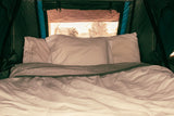 Cozy RV rental interior with a comfortable bed, perfect for camping trips and outdoor adventures.
