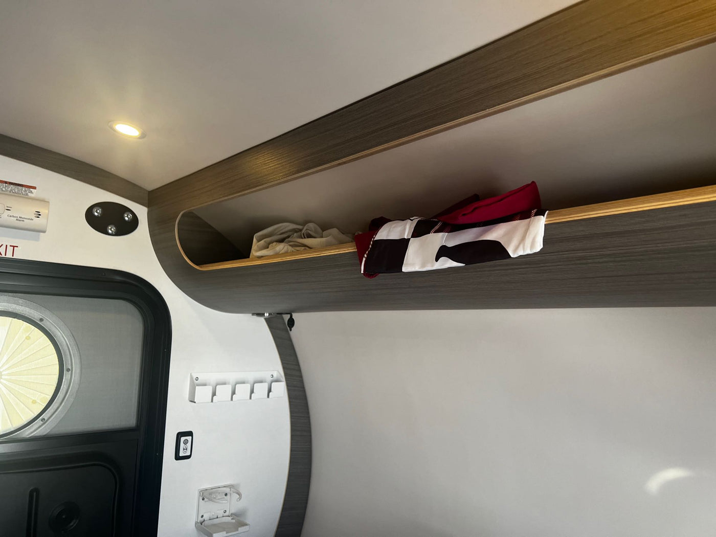  green teardrop RV rental is parked in a rustic campground at sunset — photo 15