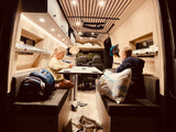 Kids enjoying card games in a cozy RV rental interior. Perfect for family adventures on the road.