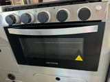 This RV rental kitchen features a stainless steel Greystone oven & stovetop with black control knobs, ready for cooking adventures.