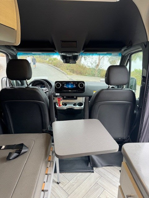  seen through a screened window.|RV rental galley features a modern sink — photo 7