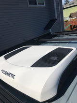Close-up of a white Dometic rooftop AC unit on an RV rental, providing cool comfort for your travels.