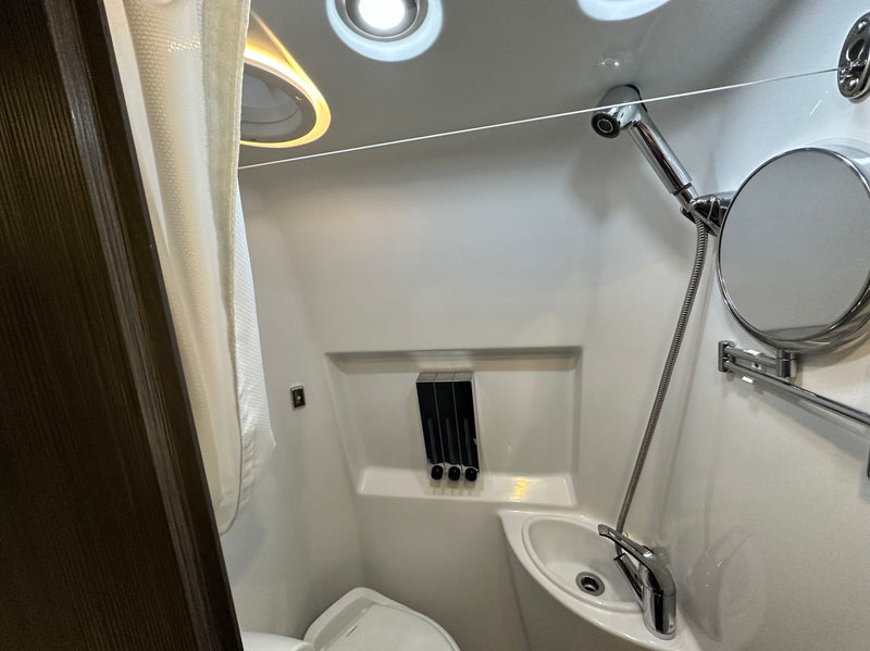  and integrated storage solutions.|This empty rv rental refrigerator awaits your groceries. Featuring interior shelves — photo 5