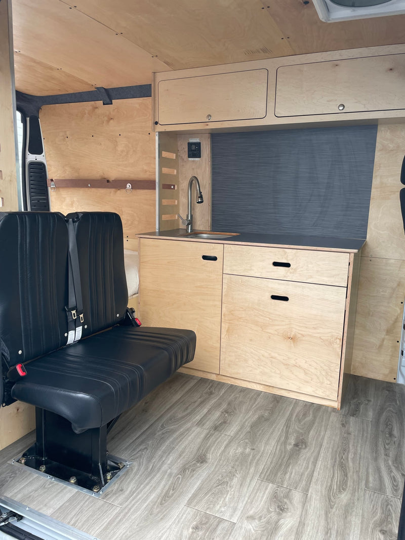  and a partial bed view.|Spacious RV rental interior featuring a cozy bed — photo 4