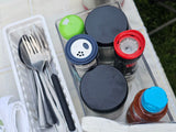 RV rental camp kitchen: Organized silverware, spices, and a pepper grinder ready for outdoor meals.