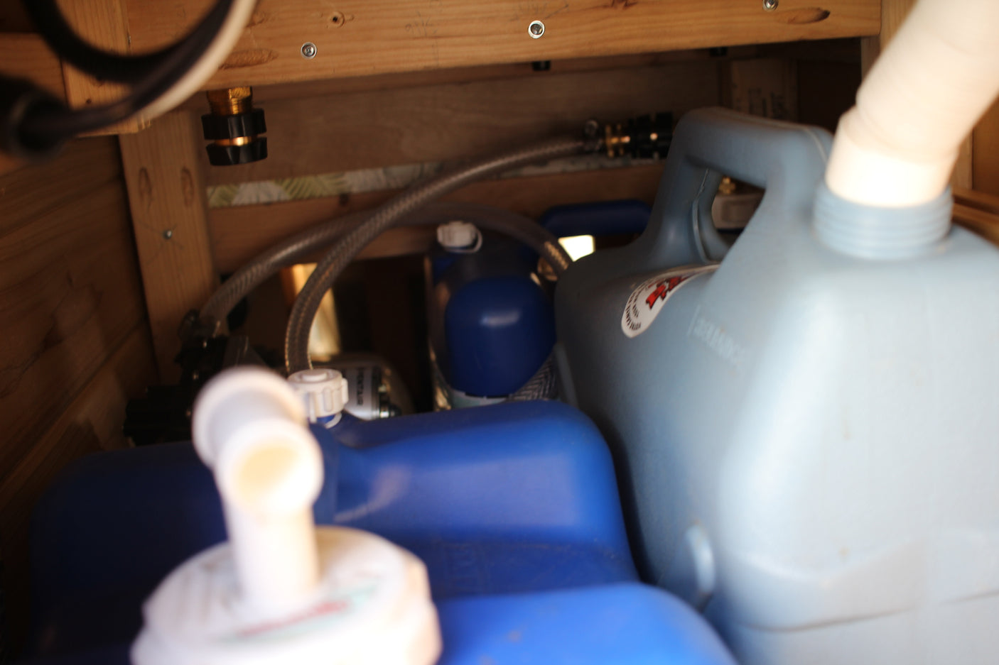 RV rental's hidden water system: fresh water containers, pump, and hoses for onboard hydration on your trip.