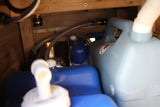 RV rental's hidden water system: fresh water containers, pump, and hoses for onboard hydration on your trip.