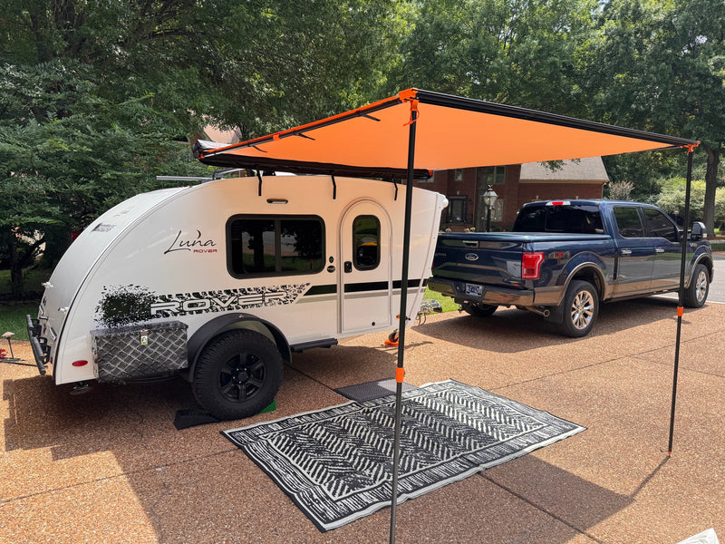  and canopy amidst green trees. Perfect for your next outdoor adventure!|White Luna Rover RV rental: close-up of side with window — photo 3