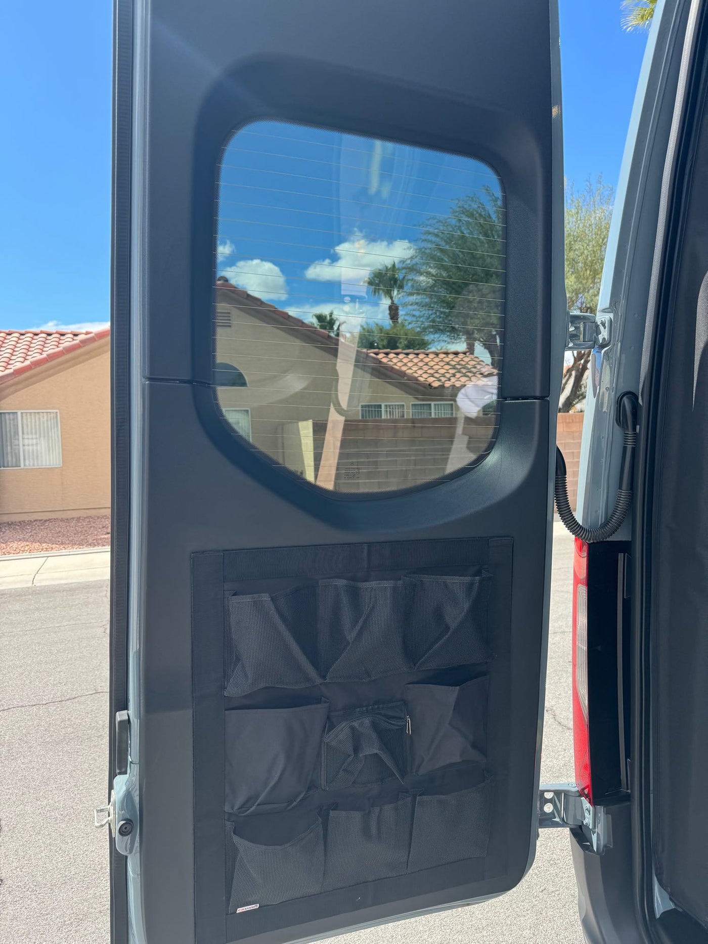 Grey camper van (RV rental) with awning & open doors — photo 10