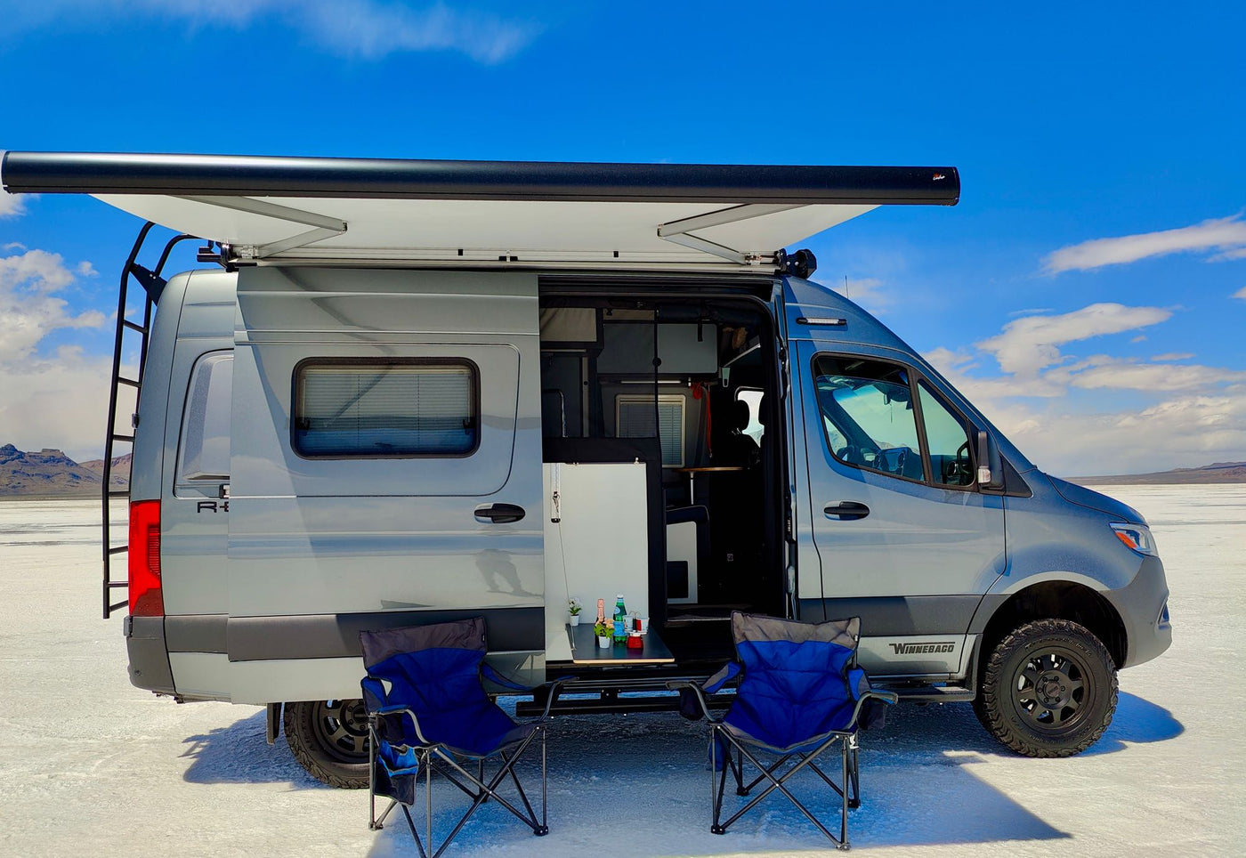 mountains under blue sky.|RV rental interior: A table with refreshments — photo 6