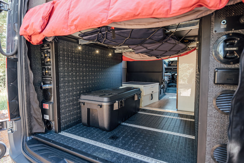  perfect for mobile adventures.|Spacious RV rental interior featuring a comfy red bed — photo 9