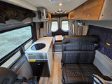 Explore this modern rv rental interior featuring a compact kitchen, plush seating, and storage, perfect for adventures.