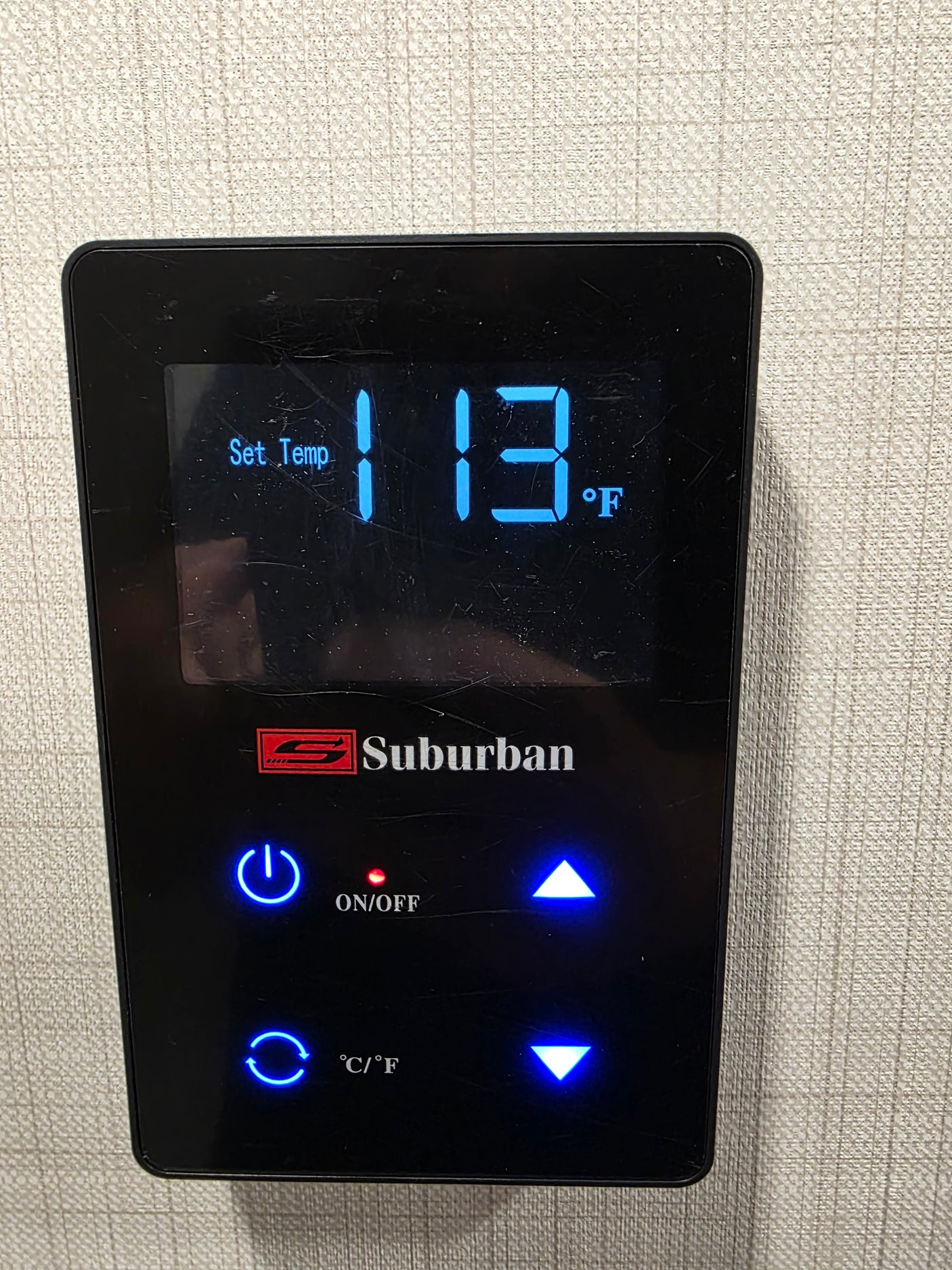 Suburban RV rental water heater control panel displays Set Temp 113°F, with illuminated power and temp buttons.