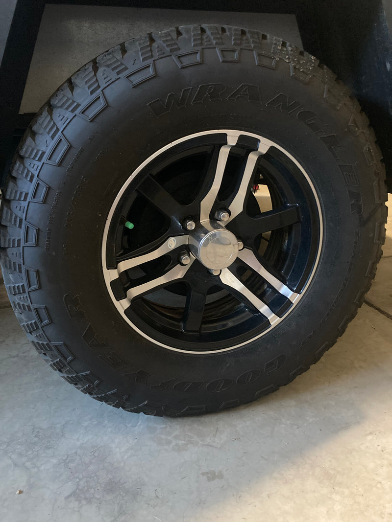 Rugged Goodyear Wrangler tire (235/75R15) and black/silver wheel, ready for your RV rental travels. — photo 17