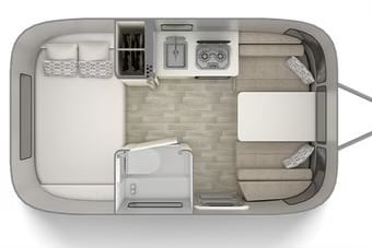 RV rental floor plan: An overhead view of a compact travel trailer interior with bed, kitchen, wet bath, and dinette. — photo 16