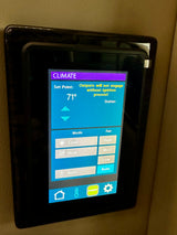 RV rental: Digital climate control panel showing 71°F, mode/fan settings, and an ignition warning in a vehicle interior.