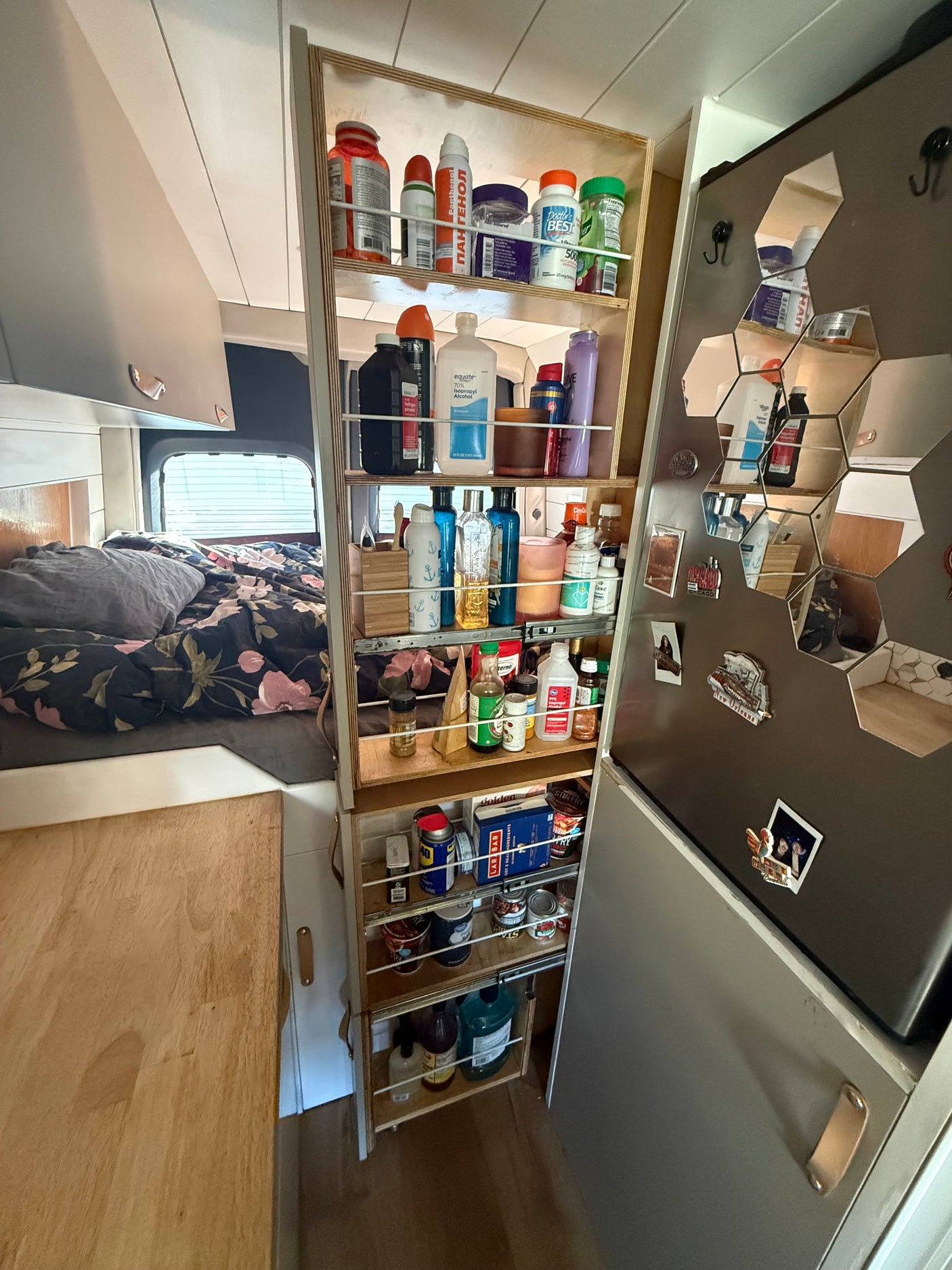 This RV rental features a clever pull-out pantry, maximizing storage for essentials next to the bed and compact kitchen area.