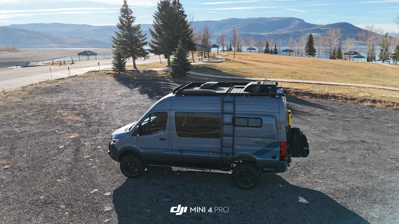  parked by a scenic lake and mountains.|Gray Storyteller Overland camper van for rv rental — photo 3