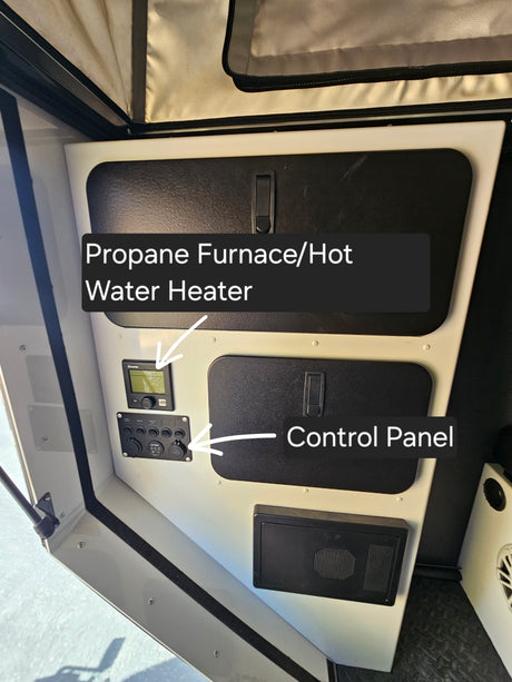 This RV rental's utility compartment features a propane furnace/hot water heater and a multi-function control panel.