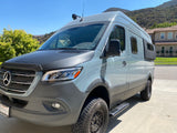Customized grey Mercedes Sprinter adventure van, ready for off-road rv rental. Explore freedom in this stylish camper!