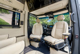 Luxurious RV rental interior with cream quilted leather seats, modern dashboard, and spacious design for ultimate travel comfort.