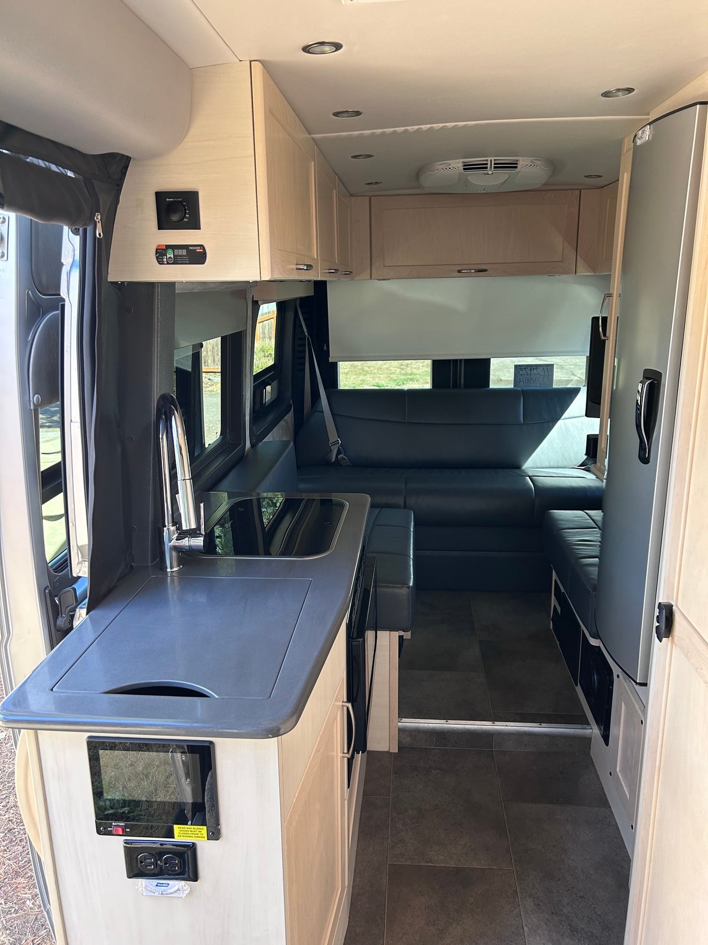  and overhead cabinets.|Compact RV rental bathroom interior — photo 6