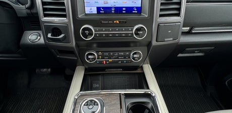 Car interior dashboard, showing infotainment, climate, USBs, and wireless charging. Great for an RV rental experience.