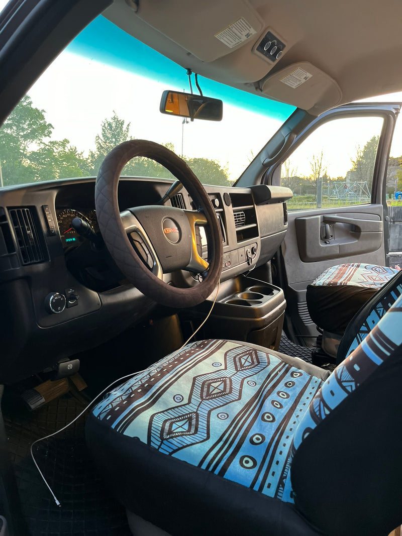 Interior of an rv rental van with steering wheel, dashboard (197k miles), and distinctive blue patterned seat covers. — photo 10