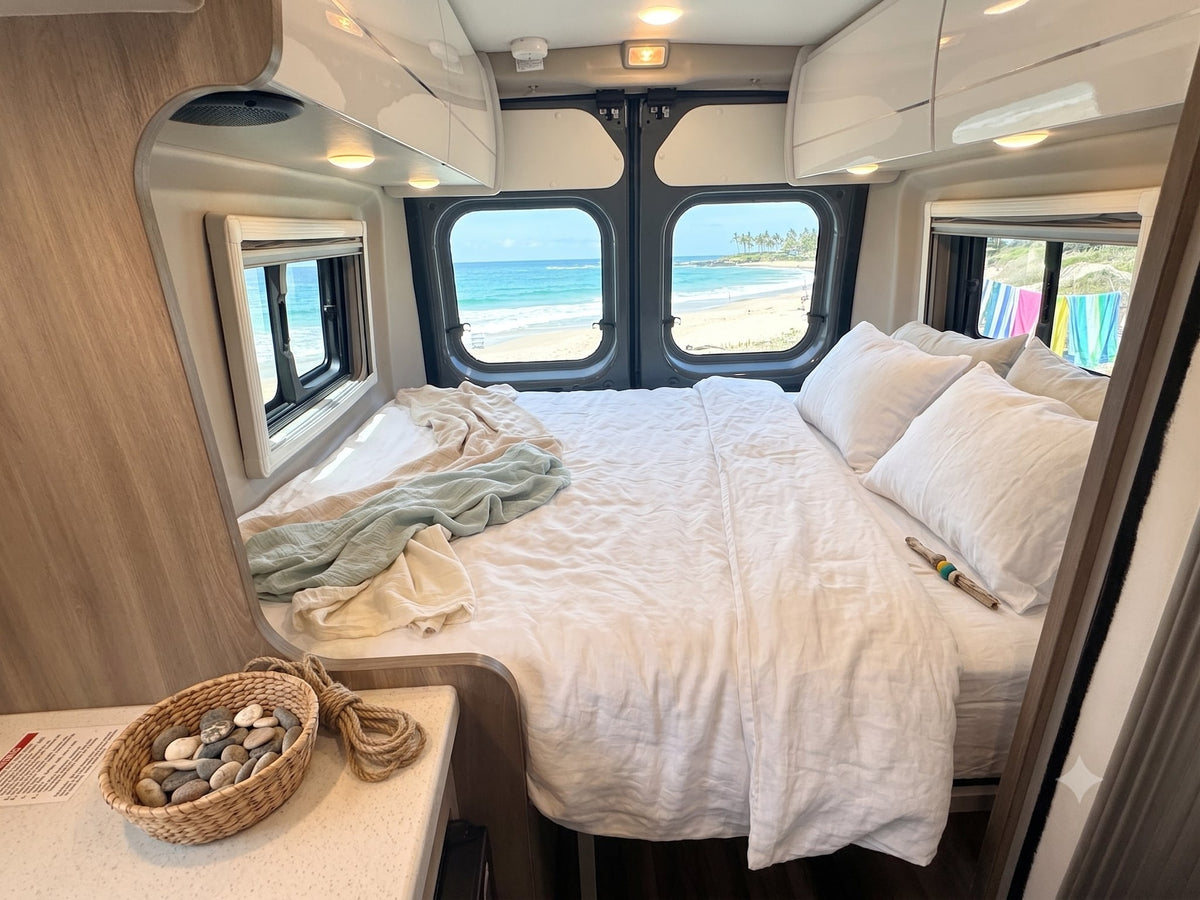  and cozy lounge area with outdoor views.|Modern RV rental interior showing a compact kitchen with microwave — photo 9