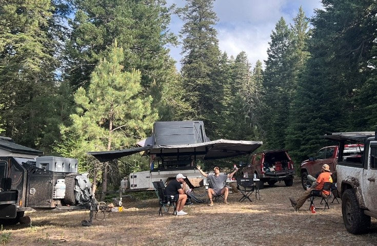  perfect for an RV rental outdoor adventure.|White off-road expedition trailer with roof-top tent & storage