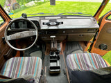 Cozy interior of a retro VW camper van, ideal for rv rental adventures. Features dashboard, steering wheel & custom seats.