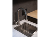 RV rental interior: Modern faucet running water into a stainless steel sink. Compact kitchen space.