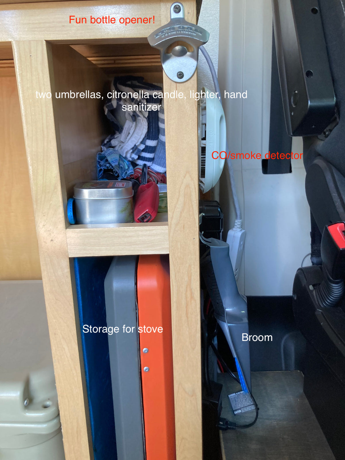 RV rental storage: compact shelves hold travel essentials like umbrellas, stove, broom, plus a bottle opener & detector. — photo 11