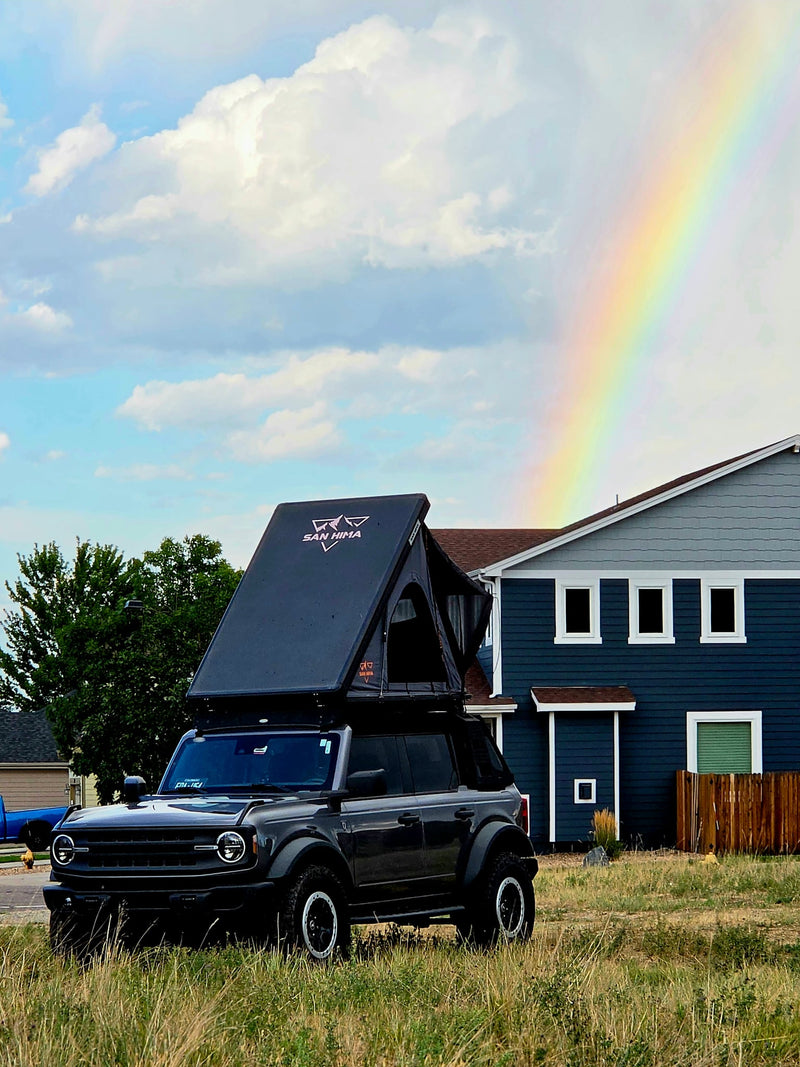  is perfect for an RV rental outdoor adventure under a vibrant rainbow.|Adventure-ready gray Ford Bronco with a San Hima rooftop tent — photo 7