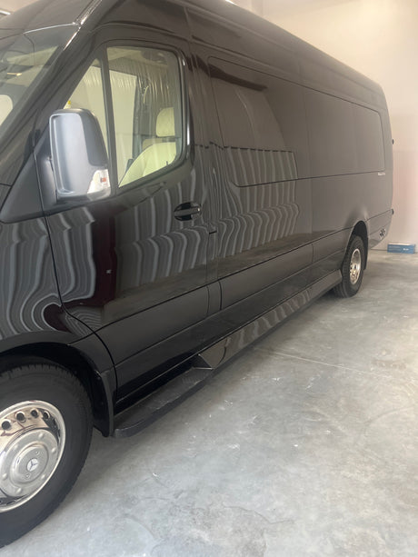 Sleek black Mercedes-Benz Sprinter van, perfect for an RV rental. Its luxury interior and polished exterior are clearly visible.