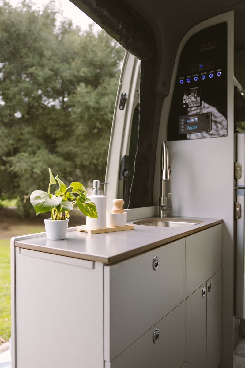  equipped for off-road adventures with a roof rack. Ideal for an RV rental.|Comfortable RV rental camper van interior. Features a cozy bed — photo 4