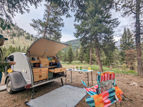Scenic rv rental campsite with an open teardrop trailer