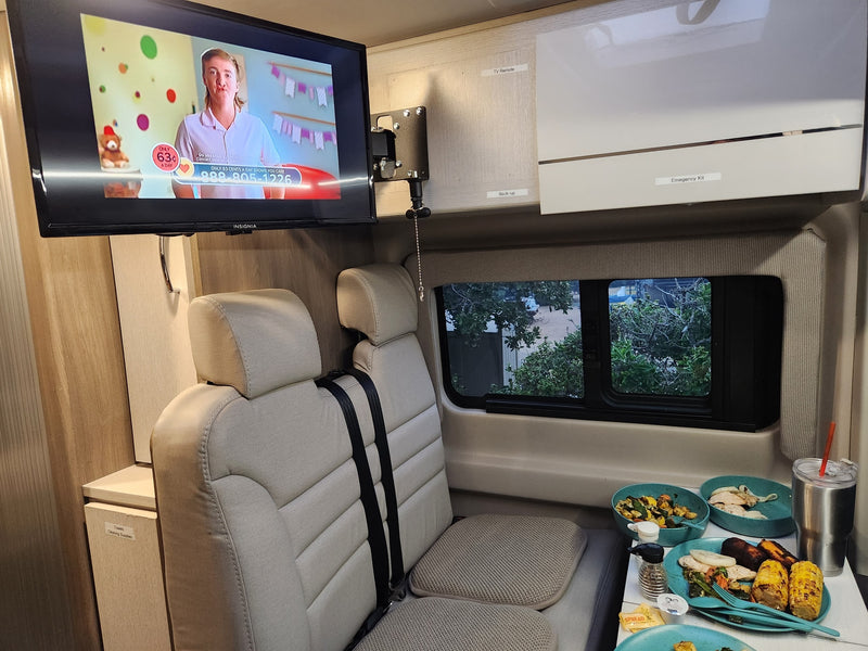  overhead storage labeled 'Pop-top Ladder' & 'Window Covers'.|Sleek RV rental interior: kitchen with sink & fridge — photo 9