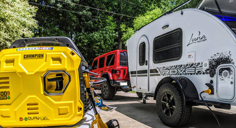 A Champion dual-fuel generator powers a Luna Rover teardrop RV, towed by a red Jeep. Essential gear for outdoor or rv rental trips.