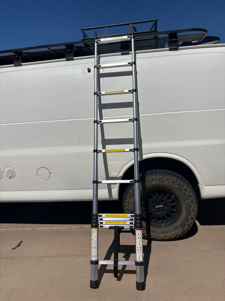 RV rental with an extended telescopic ladder providing access to its roof rack.
