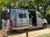 Stylish gray Mercedes Sprinter RV camper van, perfect for an rv rental, with side and rear doors open.