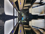 Step inside this luxury RV rental. Cream quilted seats, sleek wood, and blue accent lighting for premium comfort.